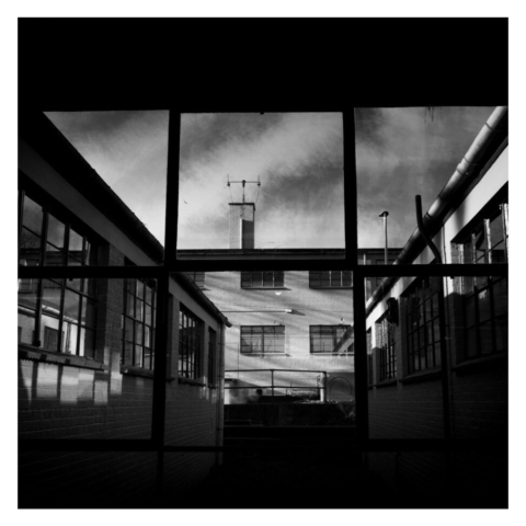 Looking ourt through the iron framed window onto the huts and buildings that hosed the codebreaking work