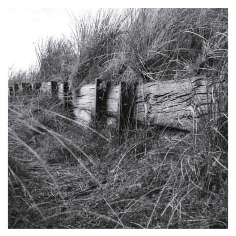 An embankment made from old railway sleepers he'd up by section of old railway line