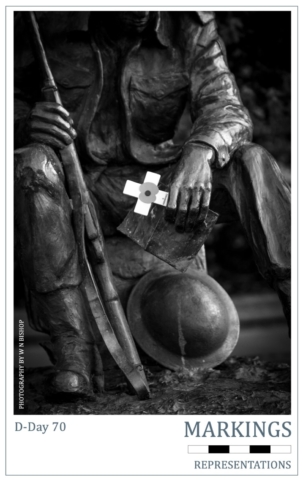 D-Day 70 Markings Series ' at the - D-Day Museum by sculpture A poppy placed in the hand of 'A Statue of A Soldier Of World War Two' at the D-Day Museum by sculpture Vivien Mallock