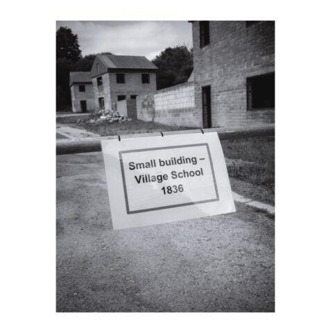 'Small building - Village School' sign marking the site of the old school - now demolished